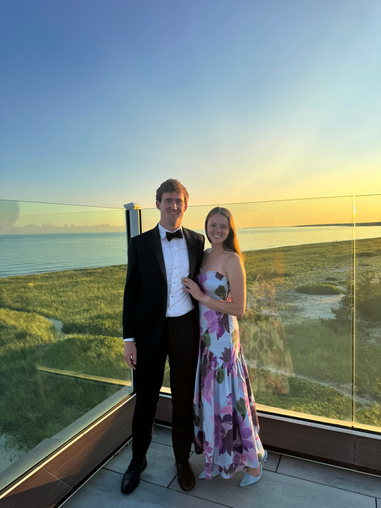 Melissa and William dressed up at sunset by the water